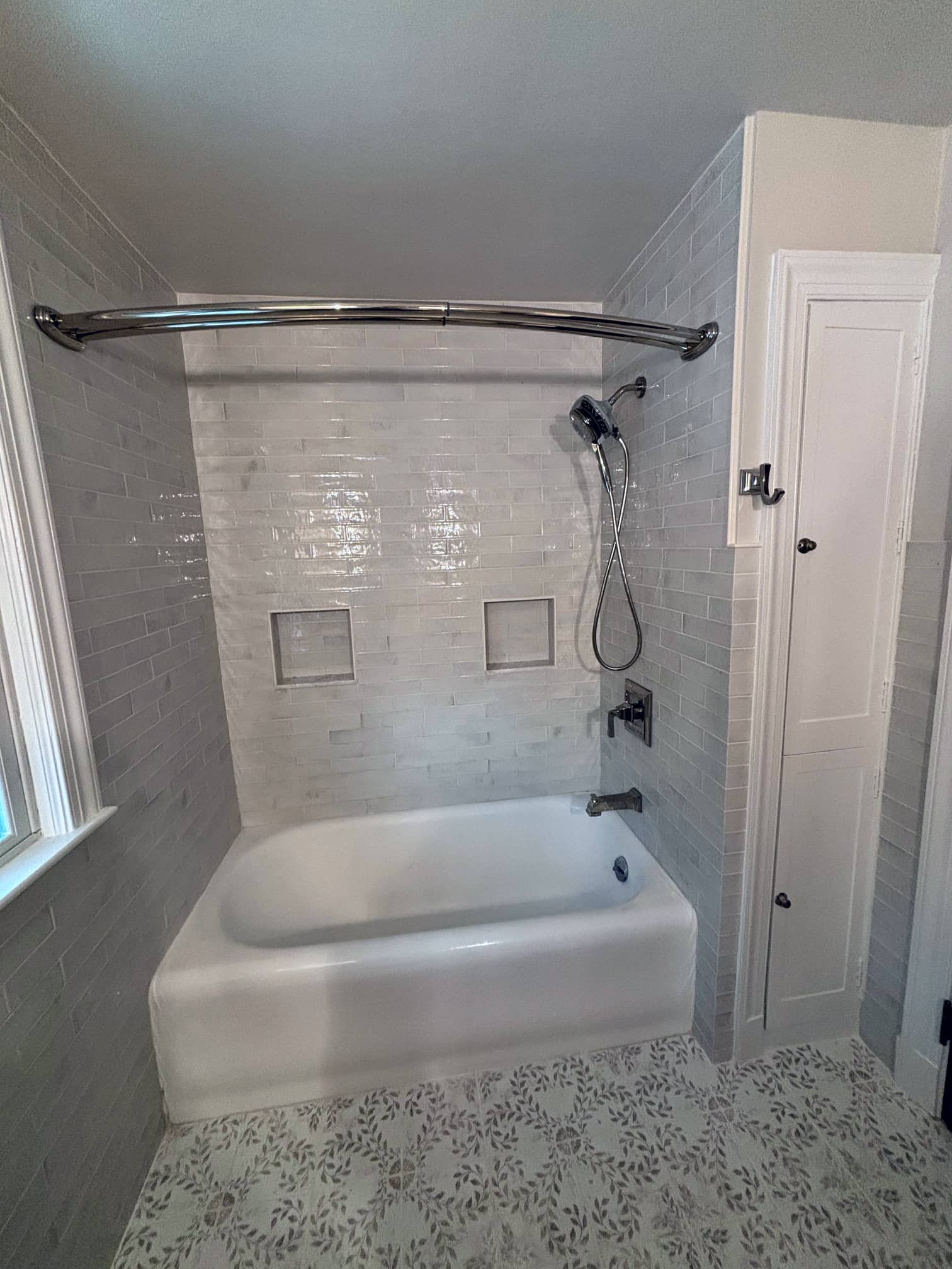 Shower and tub area with neutral tile and chrome fixtures in an East Columbus home